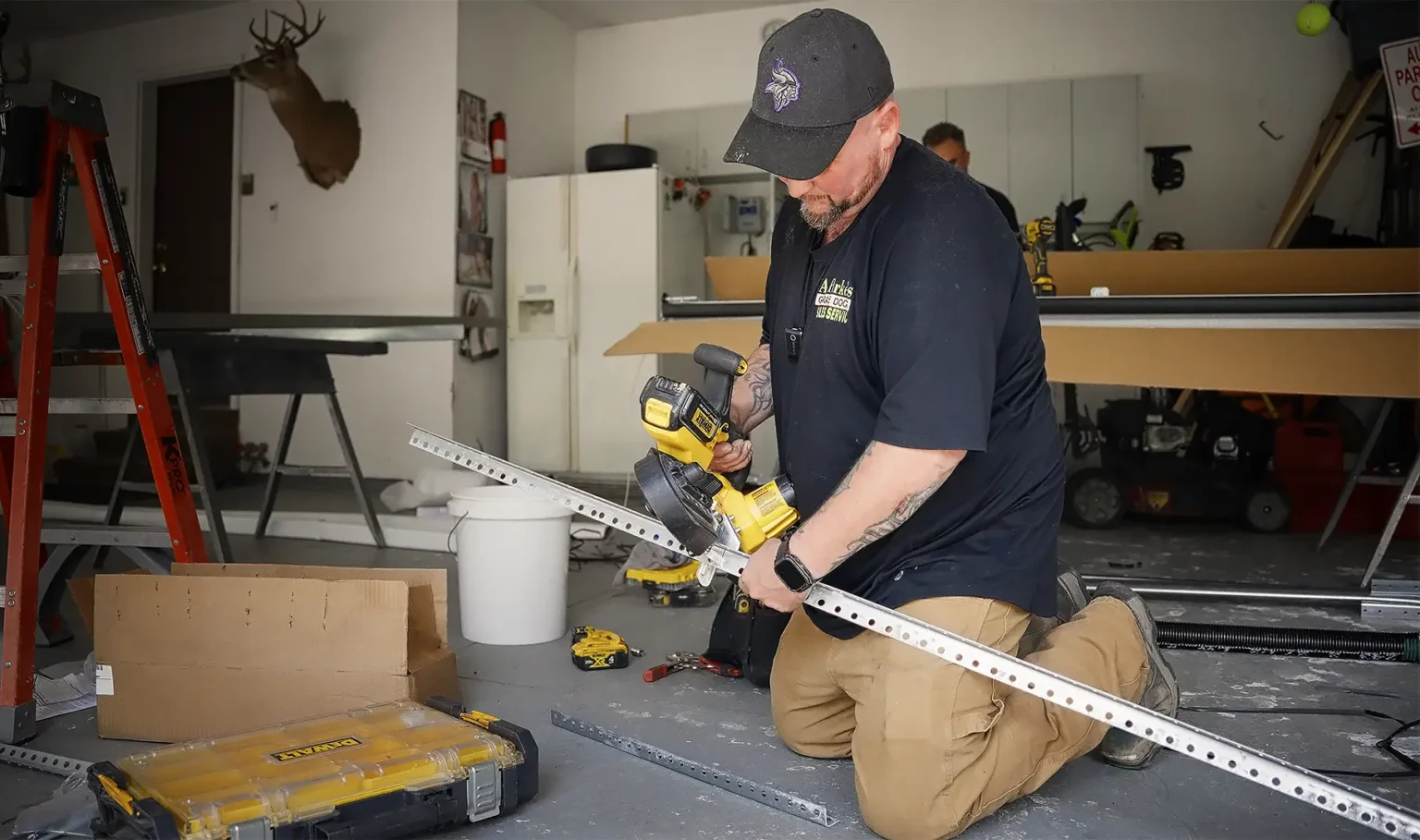 A picture of Adam working on a garage door