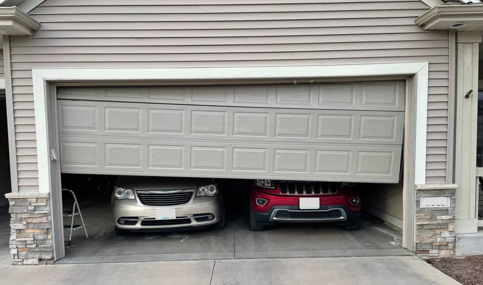 Garage door hanging uneven due to a broken cable