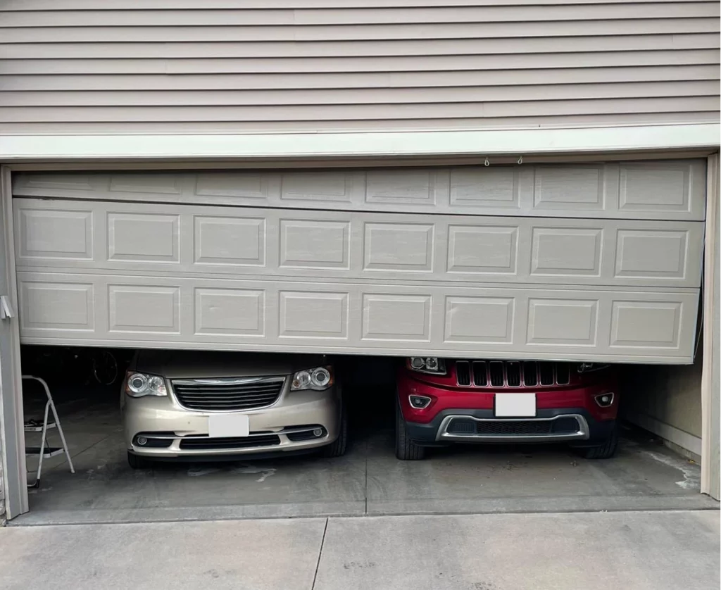 Broken garage door that we repaired for our client in Twin Cities