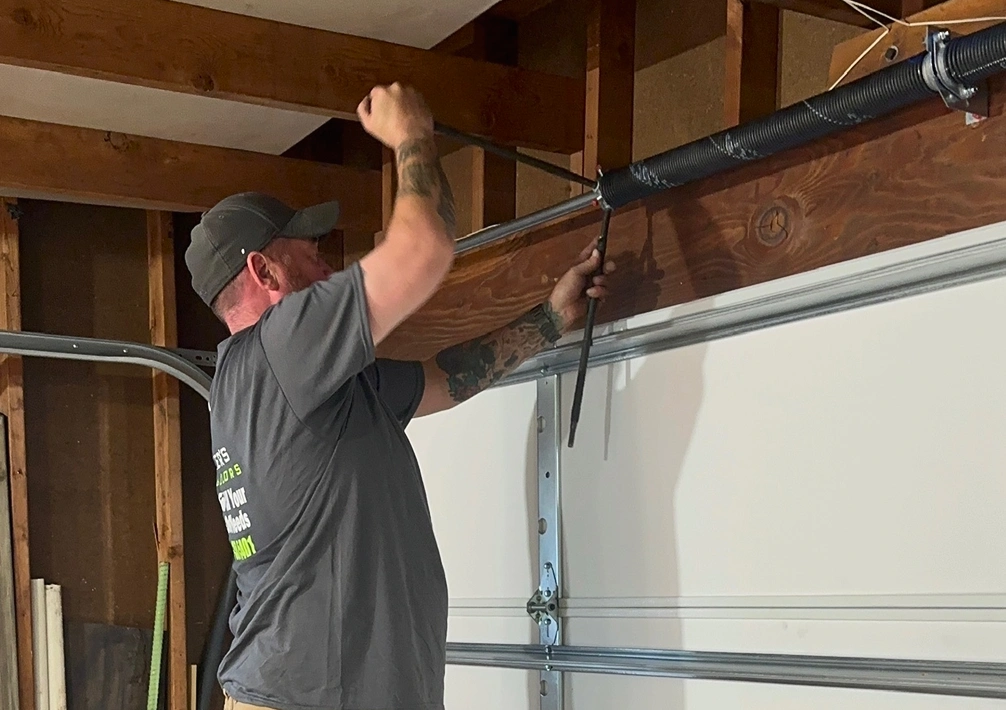 A. Parker performing garage door spring replacement service